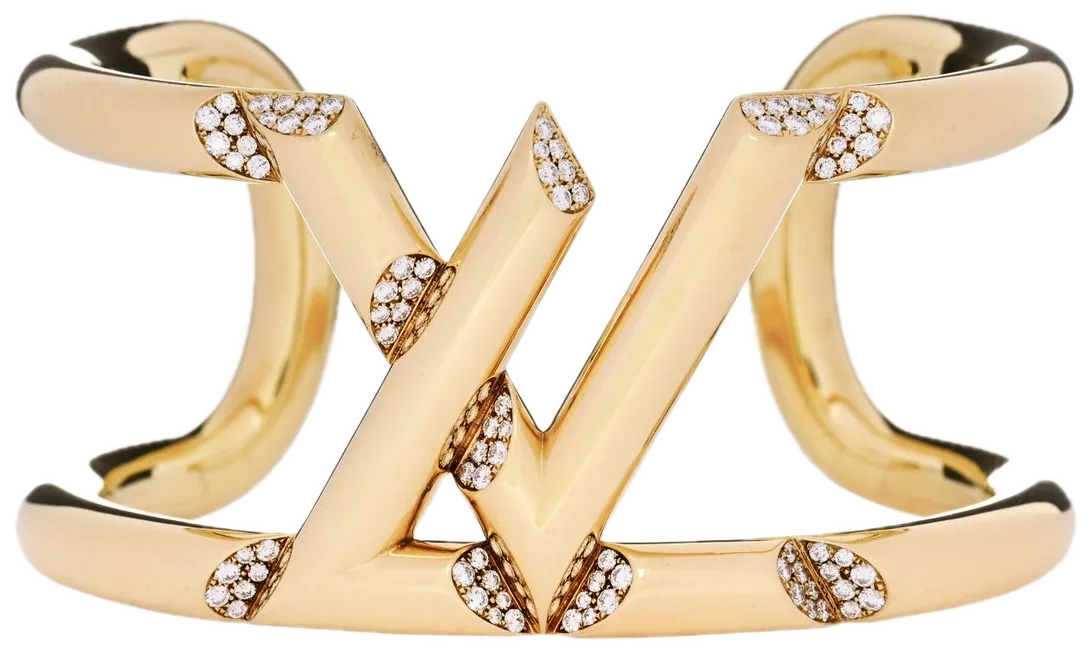 An open yellow-gold cuff bracelet with an angular V motif set with small diamonds.